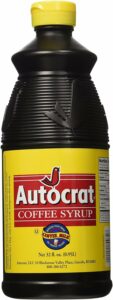 a plastic bottle of coffee syrup made by Autocrat, with a bird logo