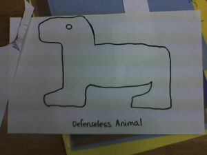 a cartoonish outline drawing of a quadruped with the caption "defenseless animal" 