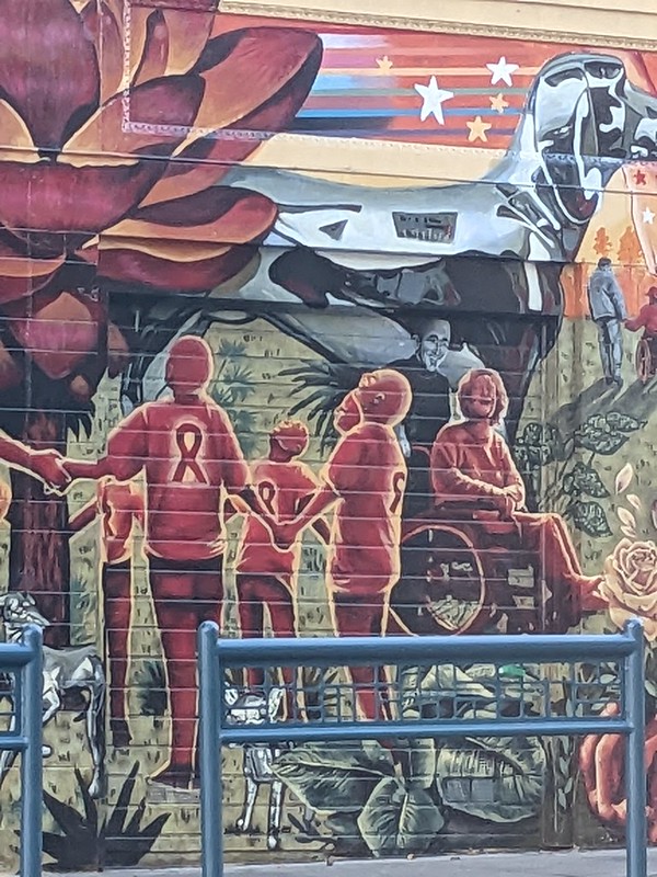 detail from a mural showing a wheelchair user looking oddly ecstatic