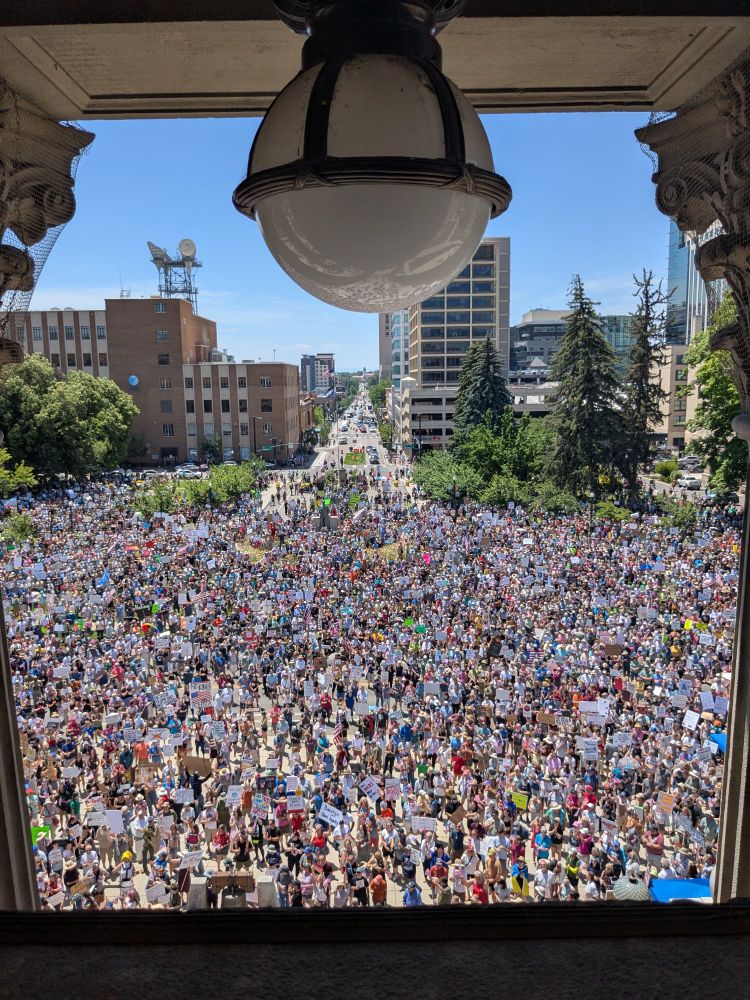 a large crowd in some public square in an unknown idaho town