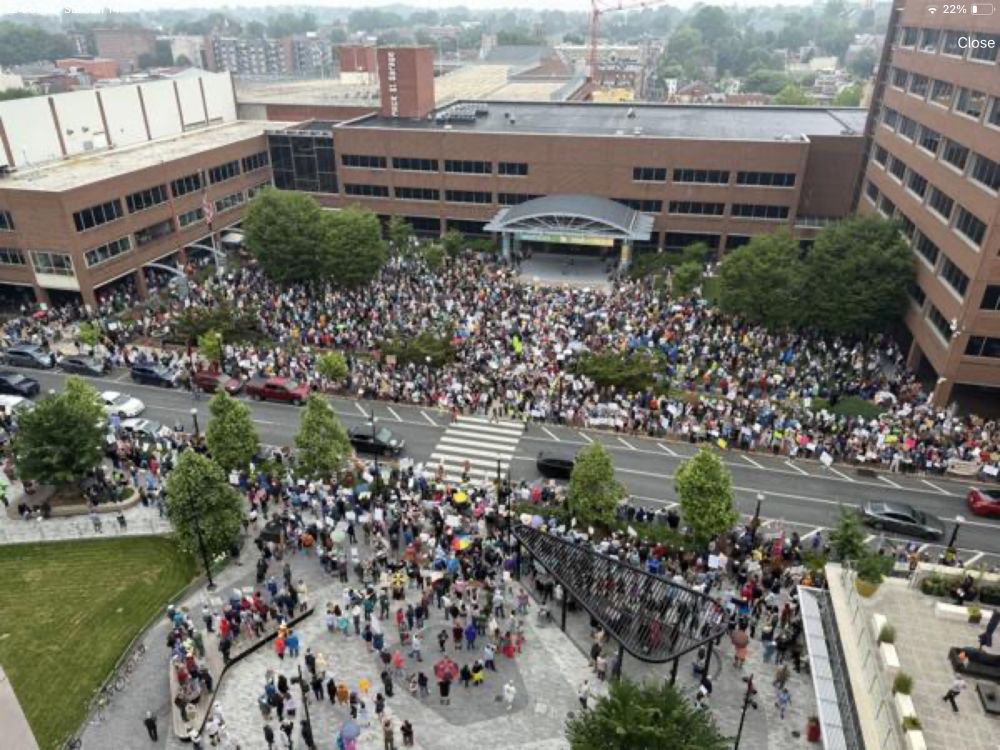 a moderately sized crowd filling a public plaza in a town in pennsylvania that i have never heard of