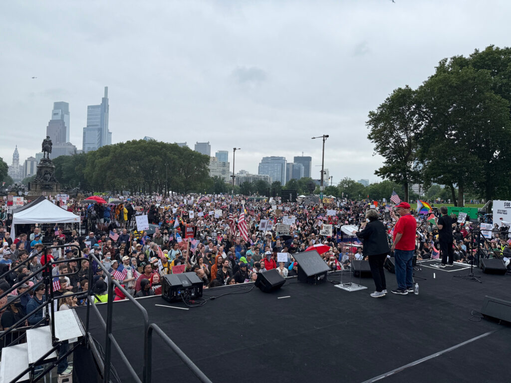 a large crowd in front of speakers in a public square in philadelphia