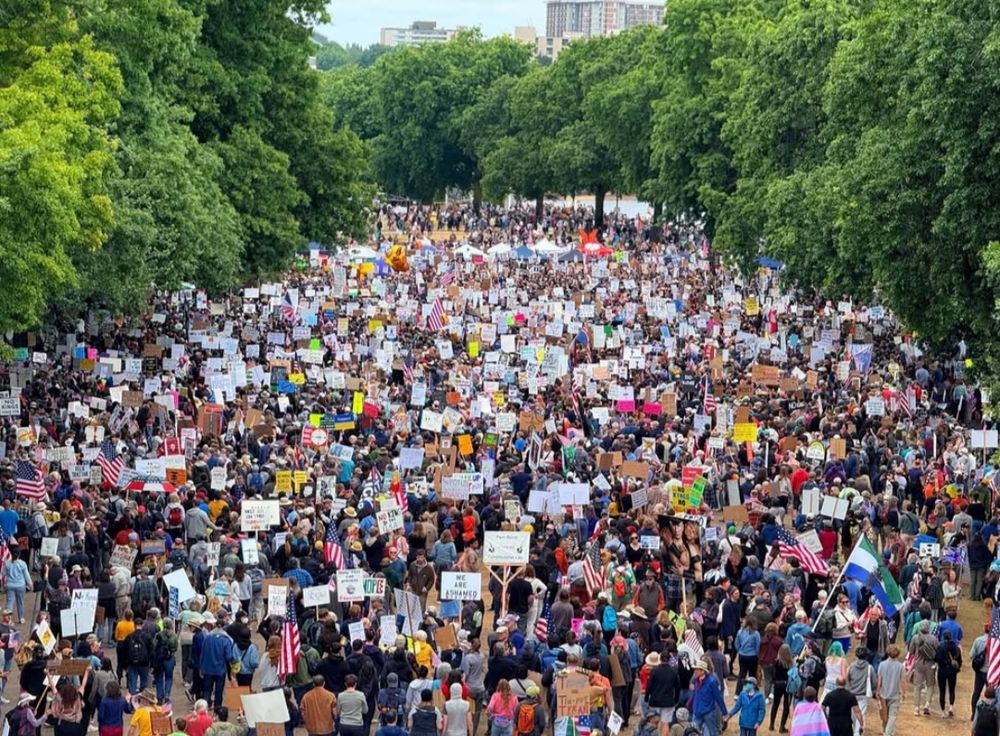jam packed street in portland, marchers with signs