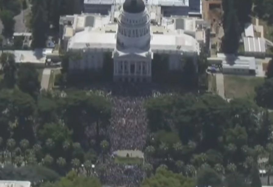 another aerial shot of a big ass crowd this one in front of the california state capitol building