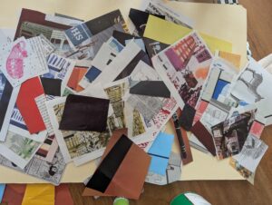 a pile of small pieces of colorful paper clipped from a magazine, spread out on a manila folder
