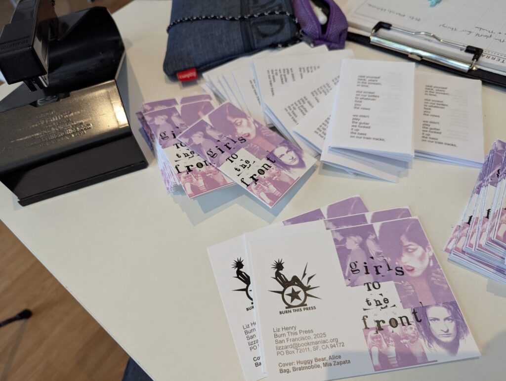 little zine covers and inside pages ready to fold, next to a saddle stapler