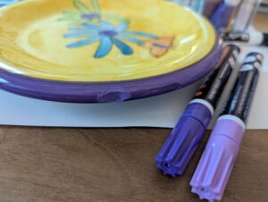 bright yellow and purple plate with the  chip in the purple rim painted over carefully